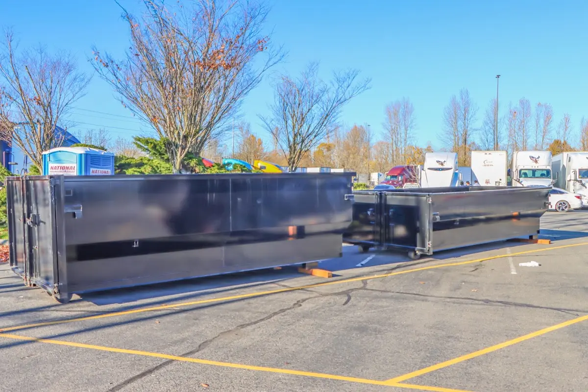 Professional dumpster rental service with roll-off container on residential driveway in Epping